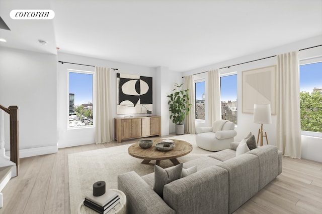 living room featuring plenty of natural light and light hardwood / wood-style flooring