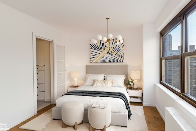 bedroom with baseboards, radiator heating unit, and an inviting chandelier