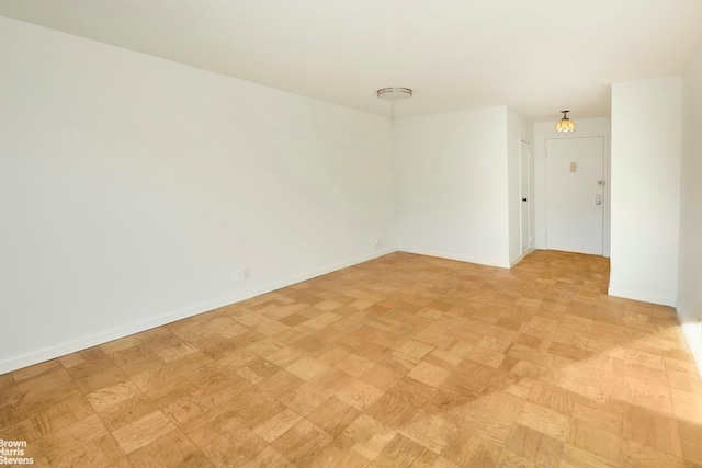 spare room featuring baseboards