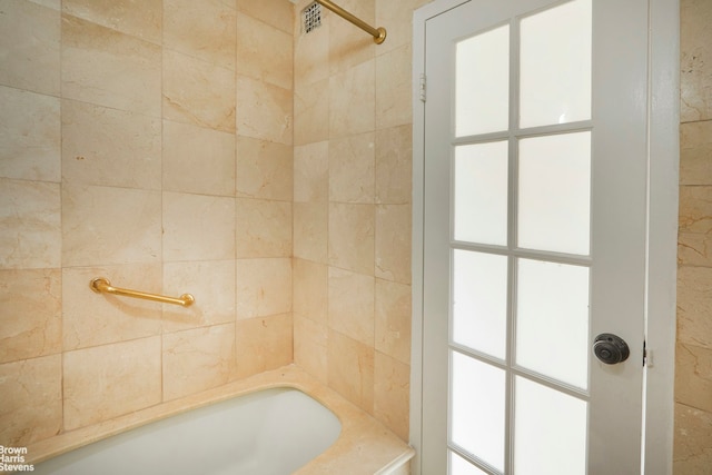 bathroom featuring walk in shower and a tub to relax in