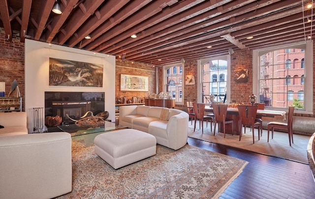 bedroom featuring brick ceiling, brick wall, and wood-type flooring