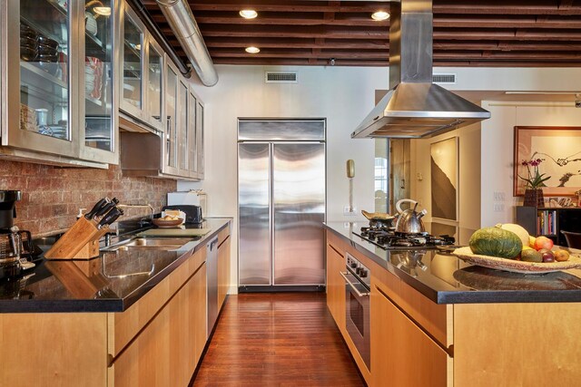kitchen with stainless steel appliances, island exhaust hood, recessed lighting, dark wood-style flooring, and backsplash