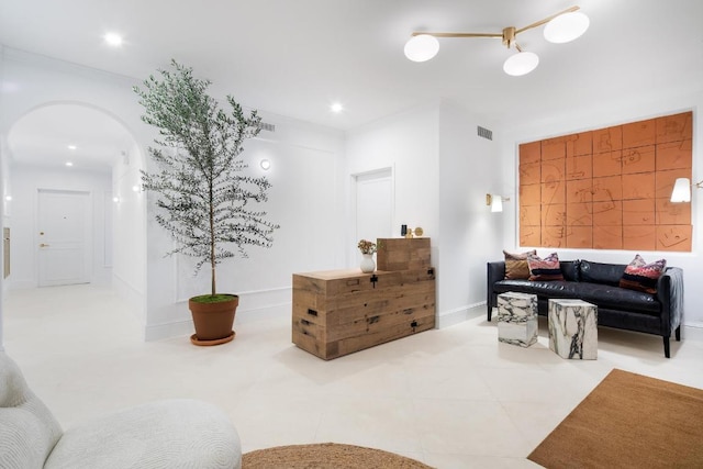 tiled living room featuring crown molding