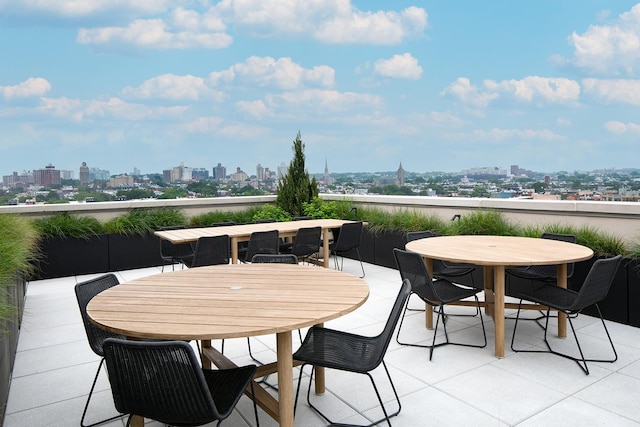 view of patio with a view of city and outdoor dining space