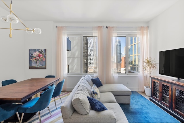 living area with a chandelier and baseboards
