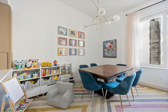dining space featuring a chandelier and baseboards