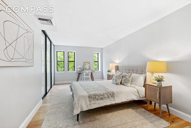 bedroom with wood-type flooring