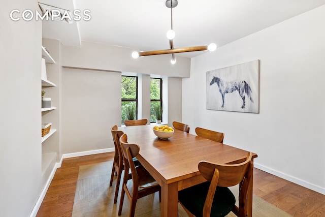 dining area featuring baseboards and wood finished floors