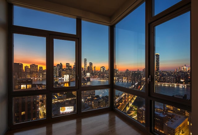 sunroom / solarium featuring a water view and a view of city