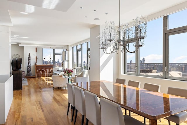 dining area featuring hardwood / wood-style flooring and a notable chandelier