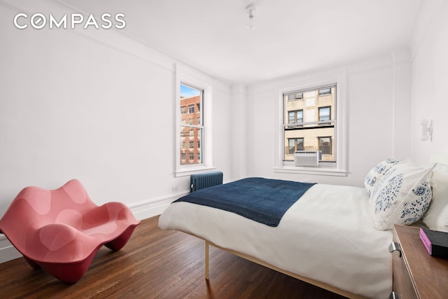 600 W 115th St Unit 1004, New York City, NY 10025 - bedroom with radiator heating unit and wood finished floors