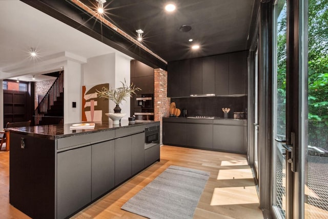 kitchen with light hardwood / wood-style flooring and a spacious island