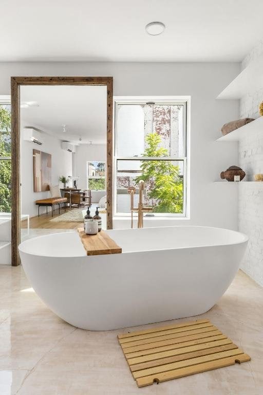 bathroom featuring a healthy amount of sunlight and a washtub