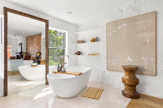 bathroom with wood-type flooring and a tub