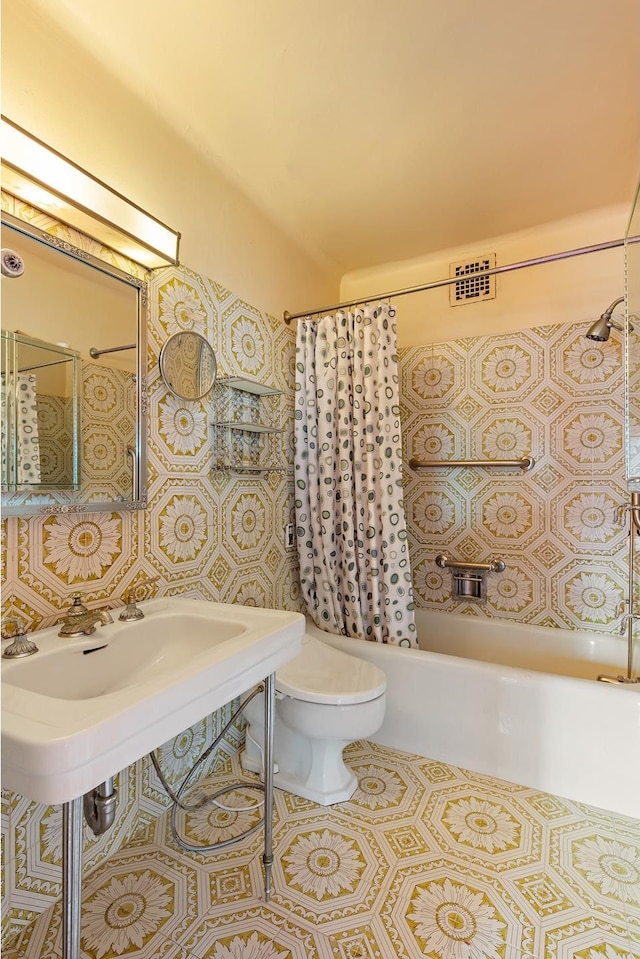 bathroom with toilet, tile patterned flooring, and shower / bath combo