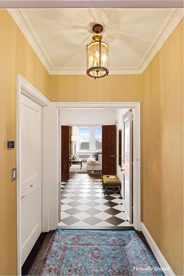 entryway featuring dark colored carpet and crown molding