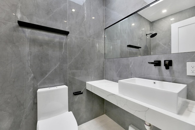 bathroom featuring toilet and tile walls