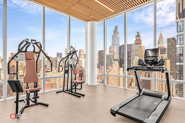 workout area featuring wooden ceiling and floor to ceiling windows