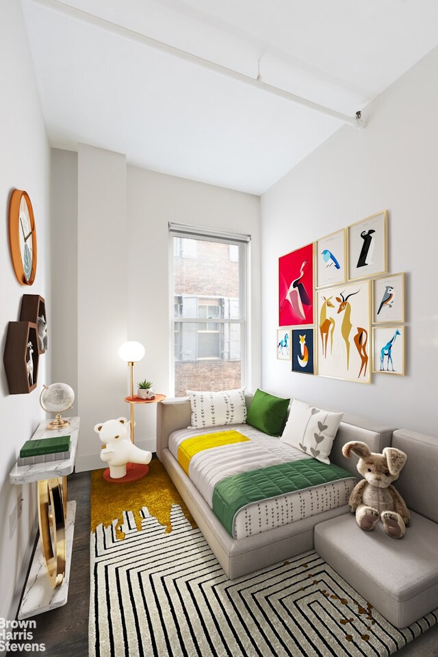 bedroom featuring baseboards and wood finished floors