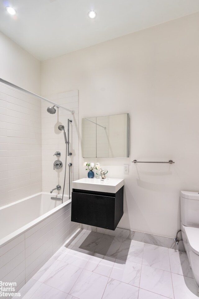 kitchen featuring appliances with stainless steel finishes, radiator heating unit, white cabinetry, decorative backsplash, and wall chimney exhaust hood