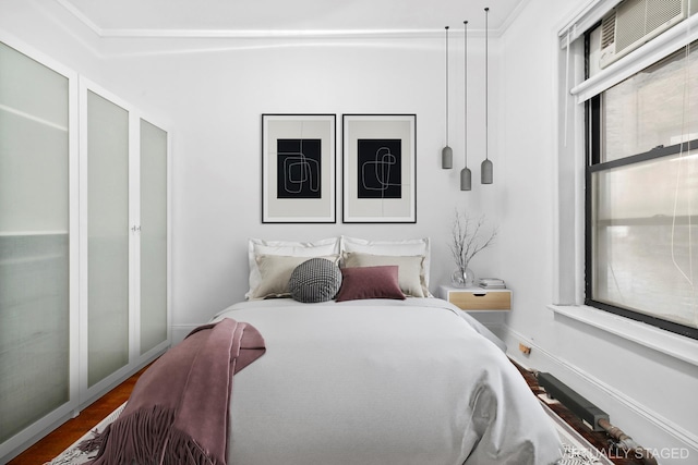 bedroom featuring baseboards and wood finished floors