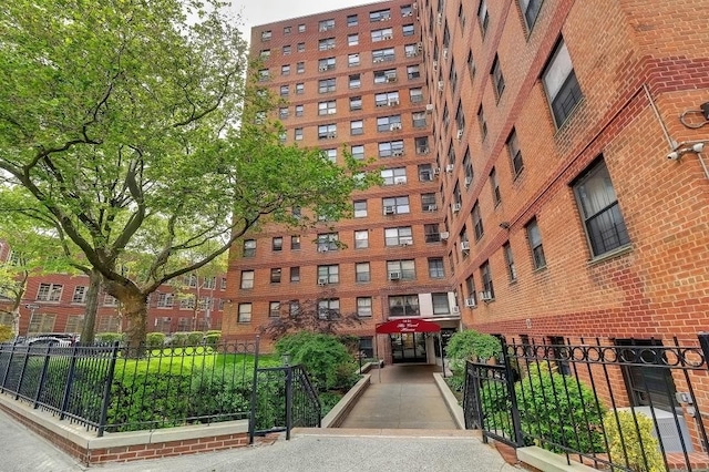 view of building exterior with fence
