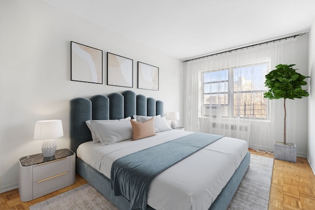 bedroom featuring light parquet flooring and radiator heating unit