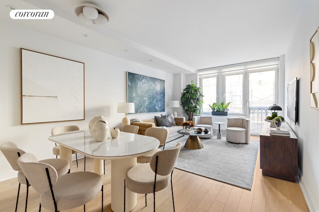 dining space with light wood-type flooring and visible vents