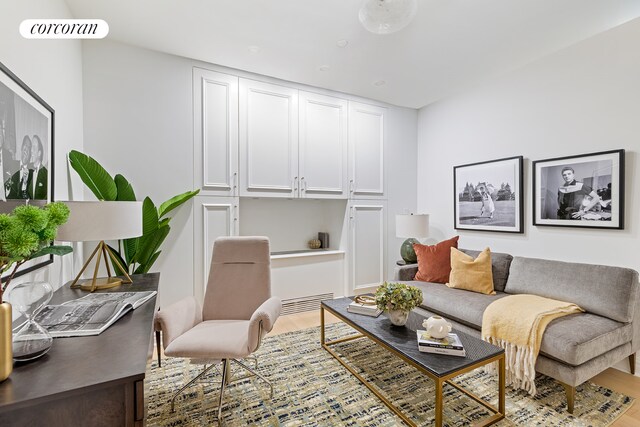 unfurnished living room featuring radiator heating unit and light wood-type flooring