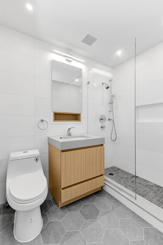 15 W 63rd St Unit 17-A, New York City, NY 10023 - bathroom with a walk in shower, tile patterned flooring, toilet, vanity, and recessed lighting