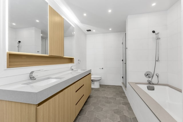 full bathroom featuring tile walls, vanity, plus walk in shower, tile patterned floors, and toilet