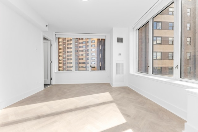 empty room with light parquet flooring