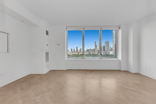 15 W 63rd St Unit 17-A, New York City, NY 10023 - unfurnished room featuring baseboards and a skyline view