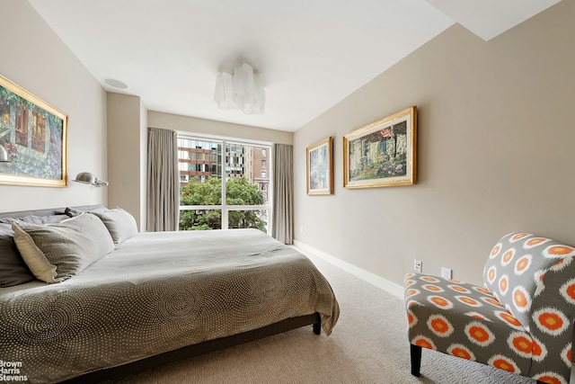 bedroom featuring carpet and baseboards