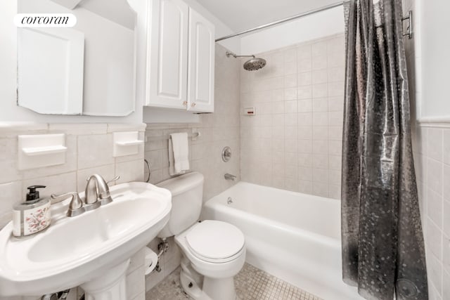 full bathroom featuring sink, shower / bath combo, tile walls, tile patterned flooring, and toilet