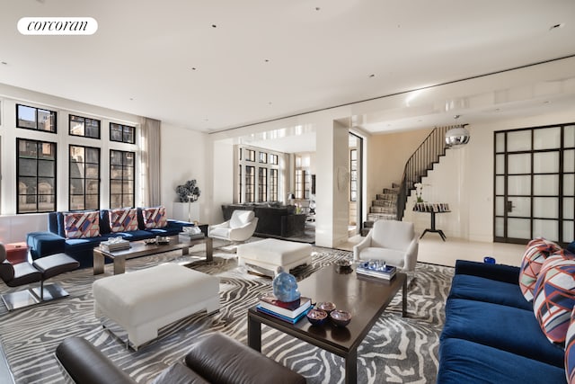 living room featuring stairway and visible vents