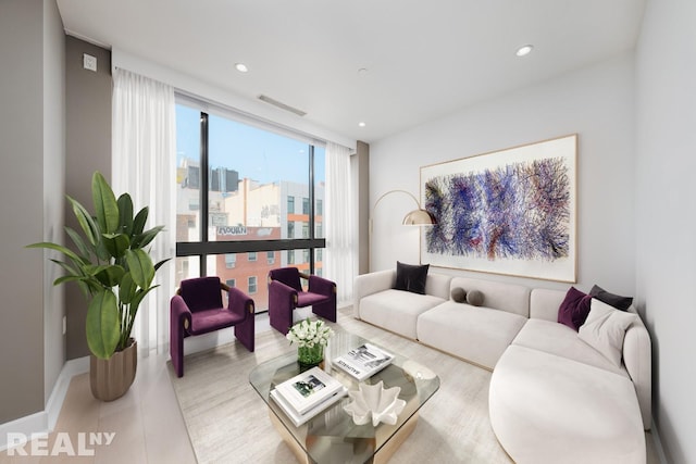 living area with recessed lighting, a city view, visible vents, baseboards, and a wall of windows