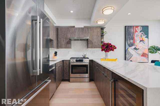 kitchen featuring beverage cooler, a peninsula, appliances with stainless steel finishes, open shelves, and modern cabinets