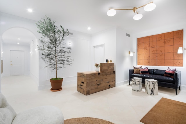 living room featuring tile patterned flooring, visible vents, ornamental molding, recessed lighting, and arched walkways