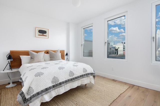 bedroom with hardwood / wood-style flooring