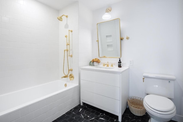 full bathroom featuring tiled shower / bath, vanity, and toilet