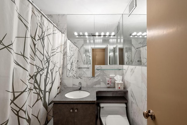 bathroom featuring toilet, decorative backsplash, walk in shower, and vanity