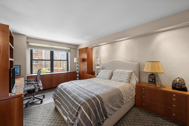 bedroom with dark colored carpet
