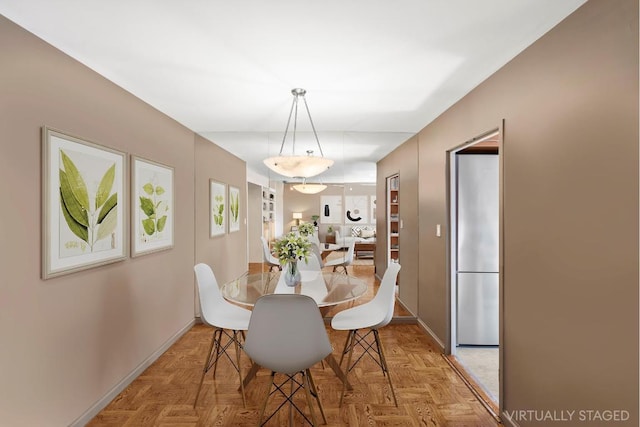 entryway with dark parquet floors and built in features