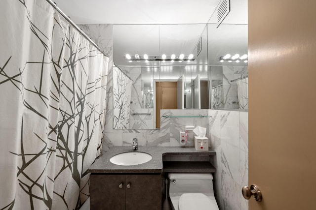 bathroom featuring decorative backsplash, visible vents, tile walls, vanity, and toilet