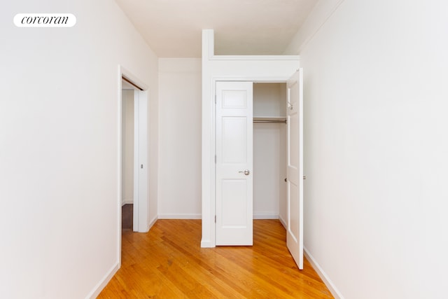 unfurnished bedroom with light wood-type flooring, visible vents, and baseboards