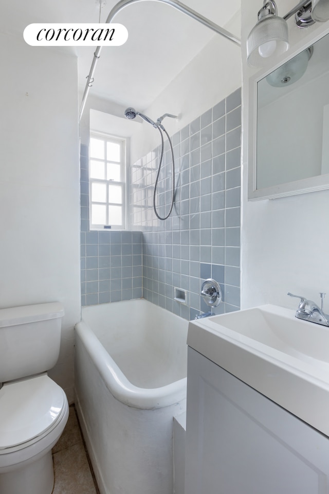 full bathroom featuring tile patterned flooring, tub / shower combination, toilet, and vanity