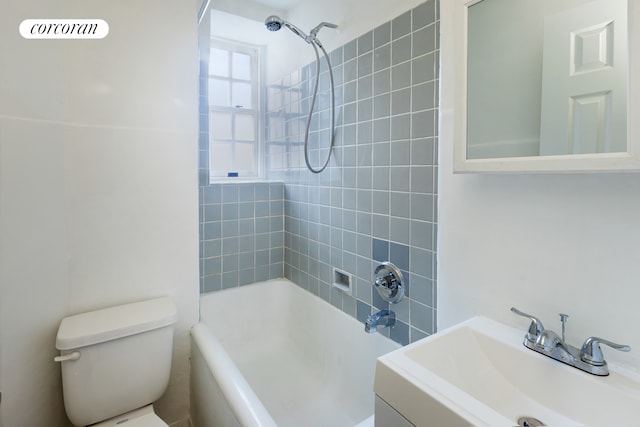 bathroom featuring vanity, toilet, and shower / washtub combination