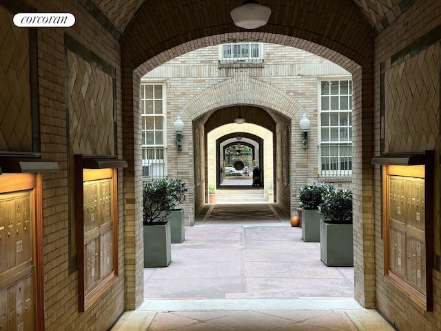 view of exterior entry featuring brick siding