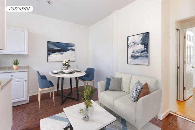 living area with visible vents, baseboards, and dark wood-type flooring